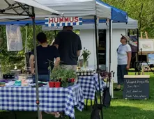 Close-up market stands and shoppers