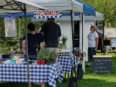 Close-up market stands and shoppers