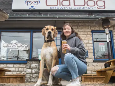 Woman and dog outside the Old Dog Brewery