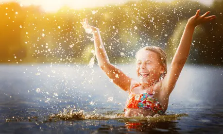 Girl splashing in a lake